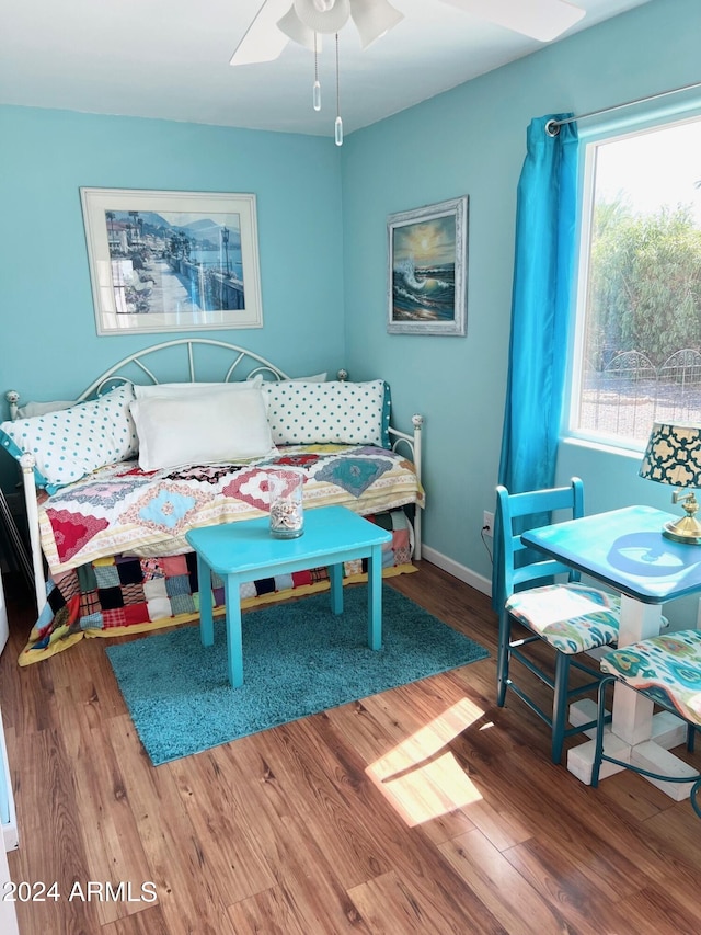 bedroom with wood-type flooring and ceiling fan