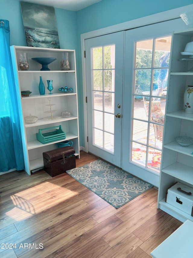 doorway with light wood-type flooring and french doors