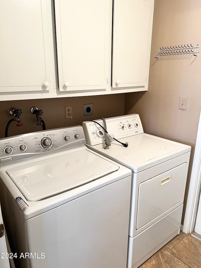 laundry room with cabinets and washer and dryer