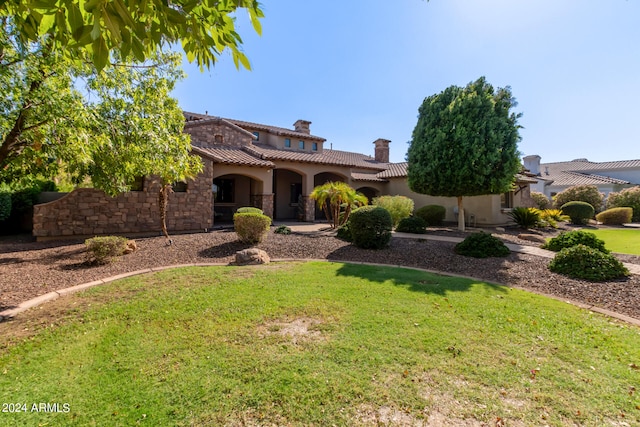 mediterranean / spanish house with a front lawn