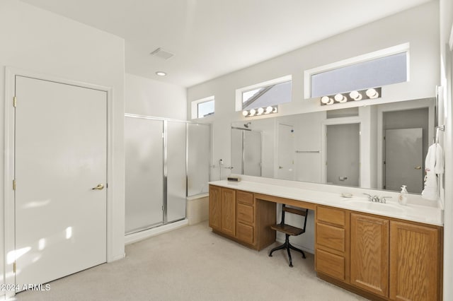 bathroom with a shower with door and vanity