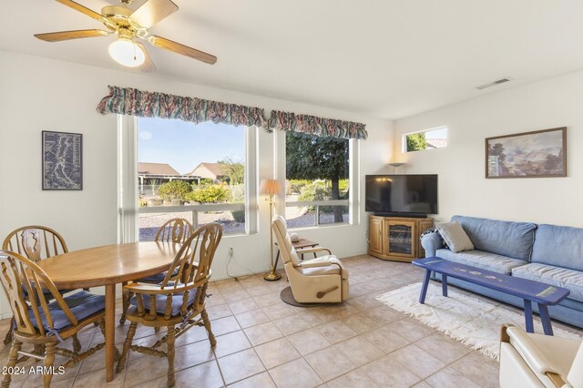 living room featuring plenty of natural light, ceiling fan, and light tile patterned floors