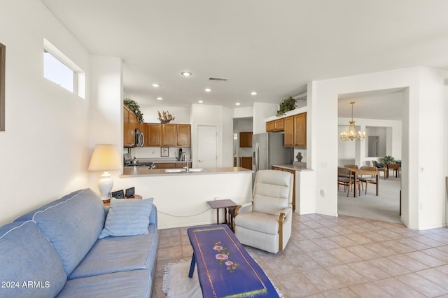 tiled living room featuring a chandelier and sink