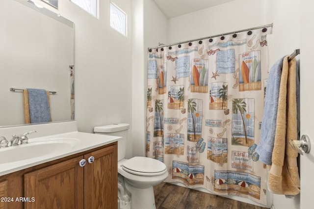 bathroom with a shower with curtain, vanity, hardwood / wood-style flooring, and toilet