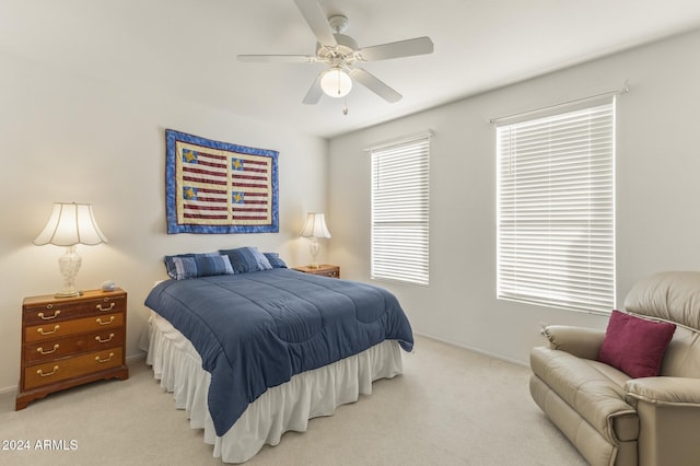 bedroom featuring light colored carpet and ceiling fan