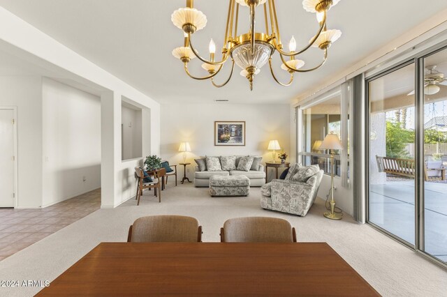 carpeted dining room with a notable chandelier