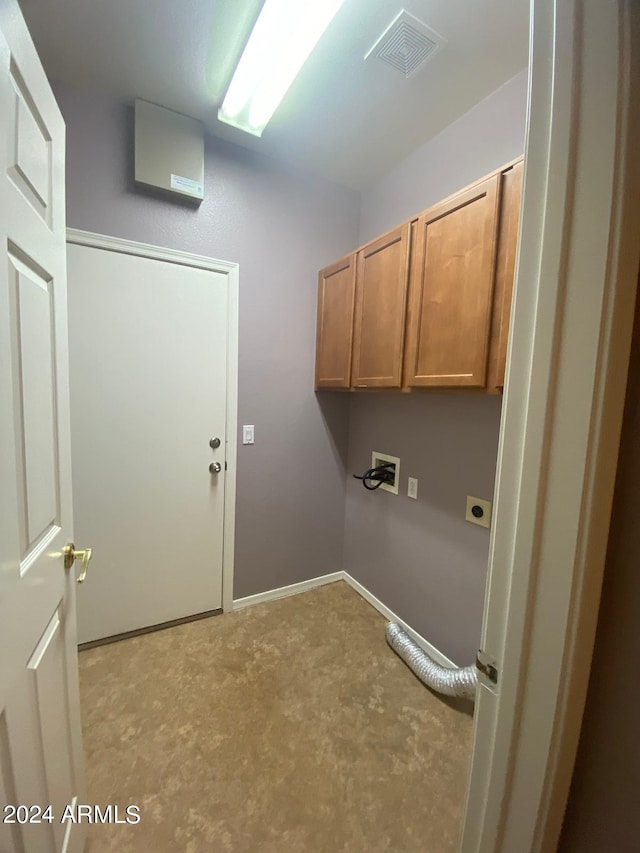 laundry room featuring cabinets, hookup for a washing machine, and electric dryer hookup