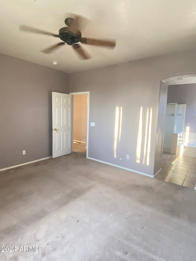 empty room with ceiling fan and light colored carpet