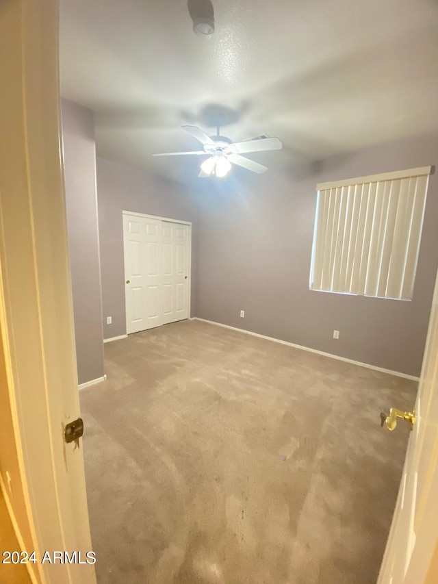 spare room with ceiling fan and carpet floors