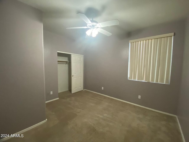 unfurnished bedroom with ceiling fan, carpet floors, and a closet