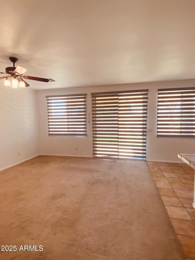 spare room with light carpet and ceiling fan