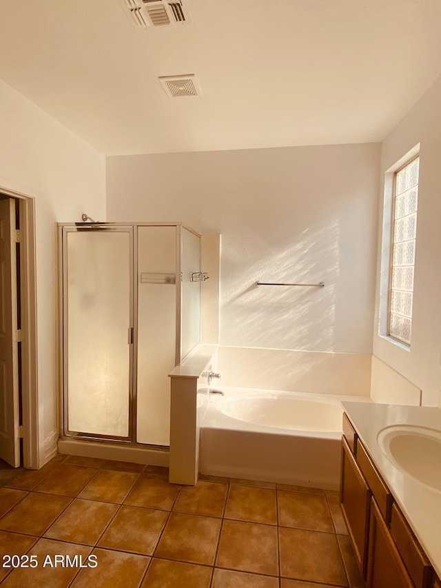 bathroom with tile patterned floors, separate shower and tub, and vanity