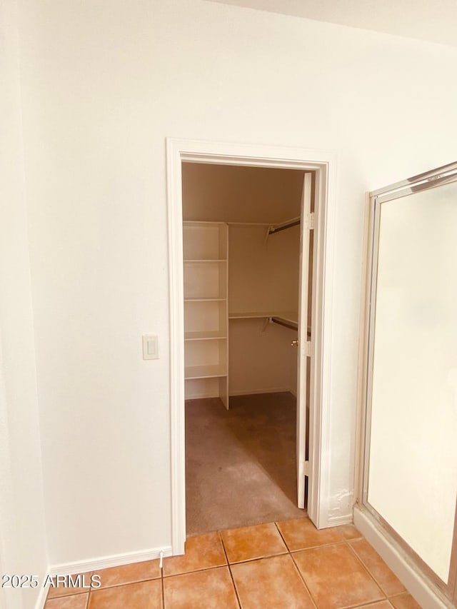 hall featuring light tile patterned floors