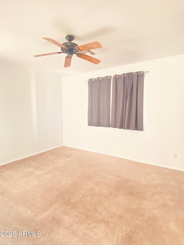 empty room featuring carpet flooring and ceiling fan