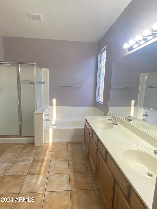 bathroom featuring tile patterned flooring, vanity, and shower with separate bathtub