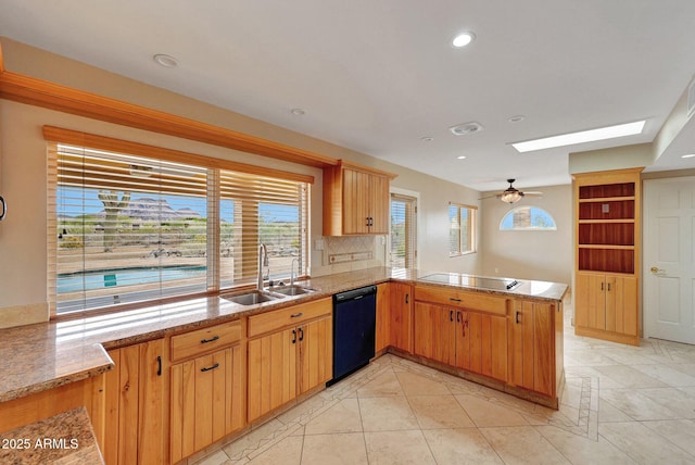 10239 N 125th St, Scottsdale, AZ 85259 - kitchen featuring black appliances, a sink, a peninsula, a skylight, and recessed lighting
