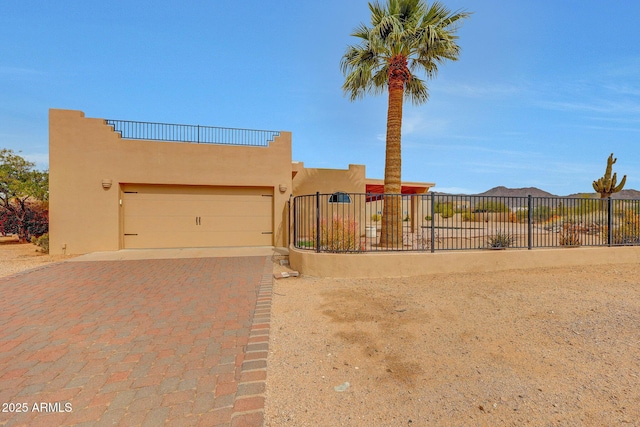 10239 N 125th St, Scottsdale, AZ 85259 - pueblo-style home with fence, stucco siding, an attached garage, and decorative driveway