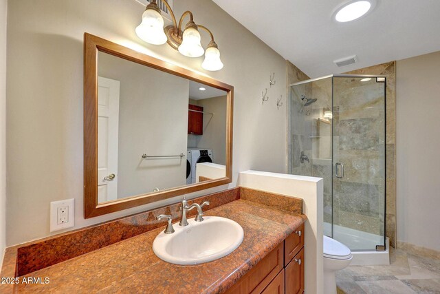 10239 N 125th St, Scottsdale, AZ 85259 - bathroom with independent washer and dryer, a stall shower, toilet, and vanity