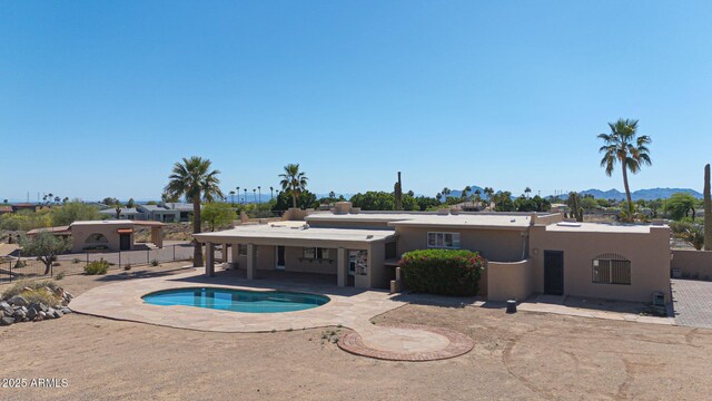 10239 N 125th St, Scottsdale, AZ 85259 - back of house featuring a patio, an outdoor pool, stucco siding, fence, and a mountain view