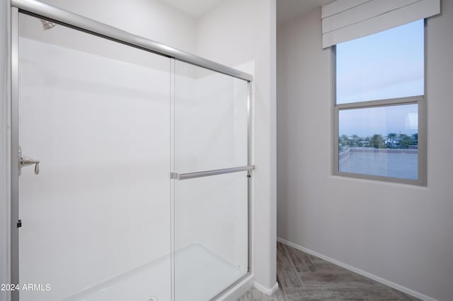 13259 N 145th Ln, Surprise, AZ 85379 - bathroom with baseboards, a stall shower, and wood finished floors