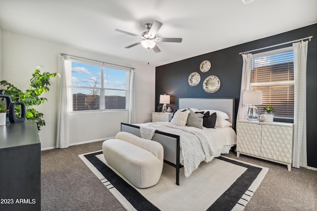 bedroom with dark colored carpet and ceiling fan