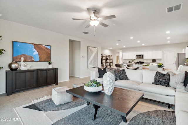 living room with light tile patterned flooring and ceiling fan