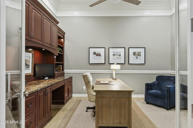 office with baseboards, light wood-type flooring, a ceiling fan, and crown molding