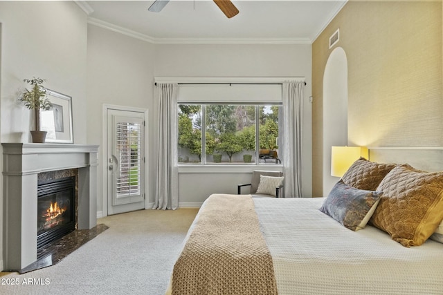 bedroom with access to exterior, visible vents, a premium fireplace, ornamental molding, and carpet flooring