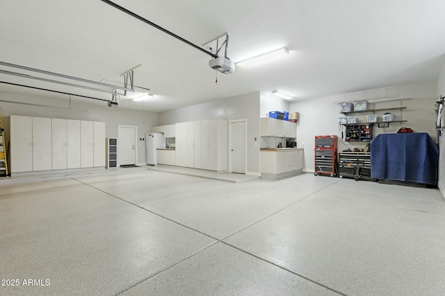 garage with freestanding refrigerator and a garage door opener