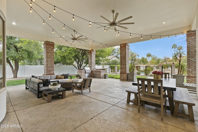 view of patio featuring outdoor dining space, ceiling fan, a fenced backyard, and an outdoor living space with a fire pit