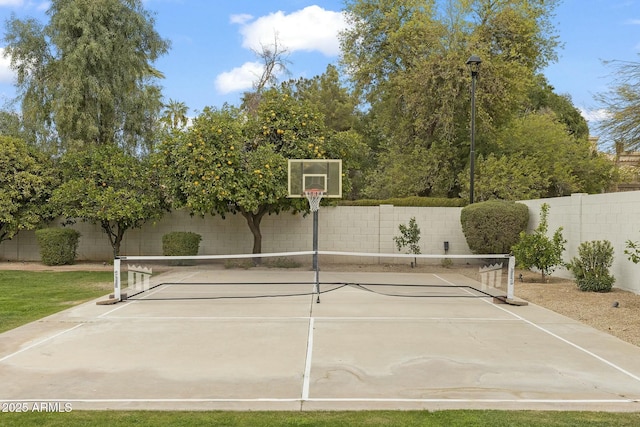 view of sport court with basketball court and a fenced backyard