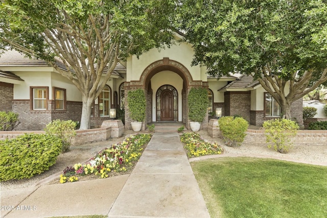 view of front facade with brick siding and stucco siding