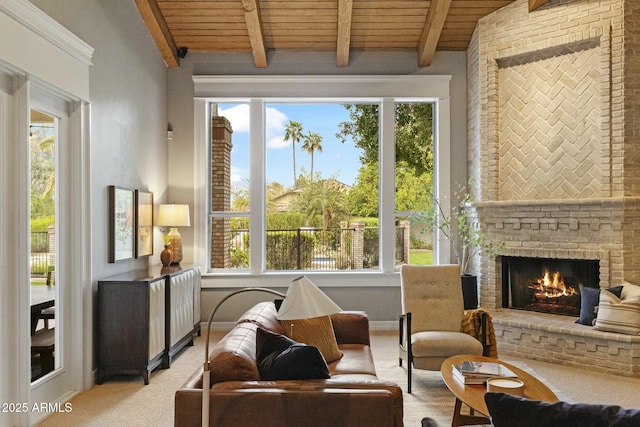 sitting room featuring plenty of natural light, wood ceiling, a fireplace, and beam ceiling