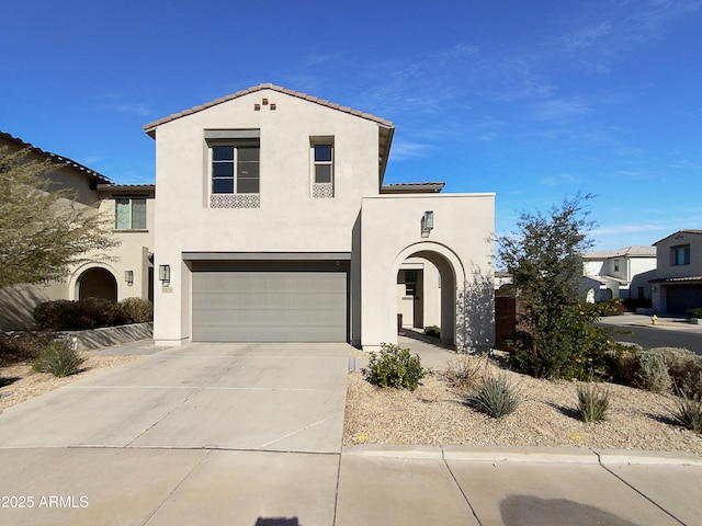 mediterranean / spanish-style home with a garage