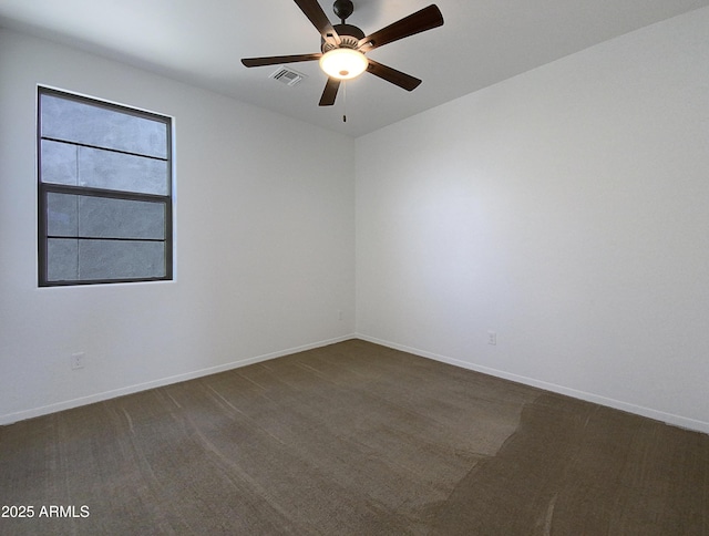 carpeted spare room featuring ceiling fan