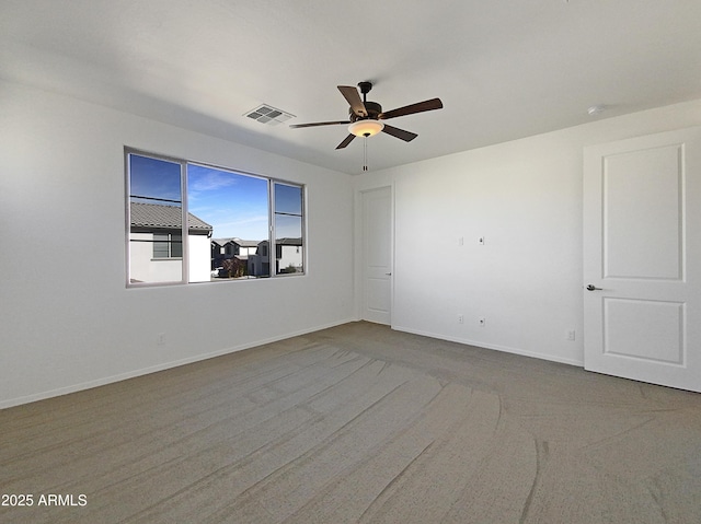 carpeted spare room with ceiling fan