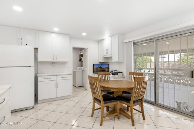 dining room with washer / clothes dryer and light tile patterned floors