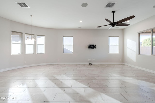 spare room featuring ceiling fan with notable chandelier and light tile patterned floors