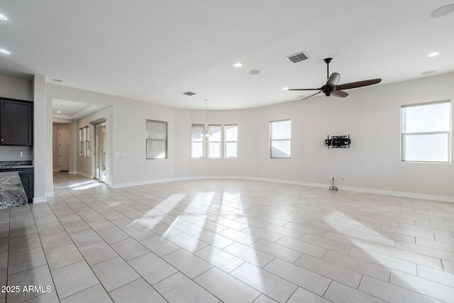 unfurnished room with ceiling fan and light tile patterned floors