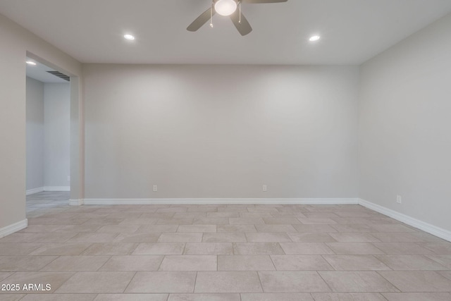 tiled spare room featuring ceiling fan