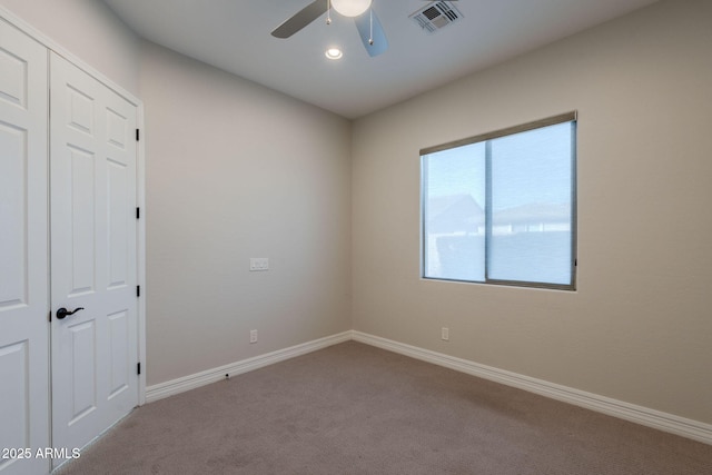 carpeted empty room with ceiling fan