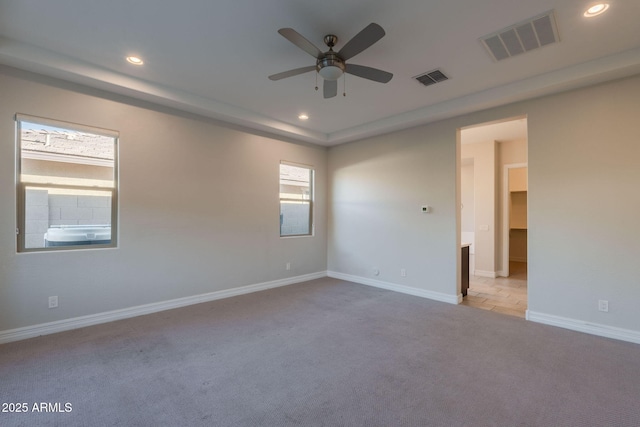 unfurnished room featuring light carpet and ceiling fan