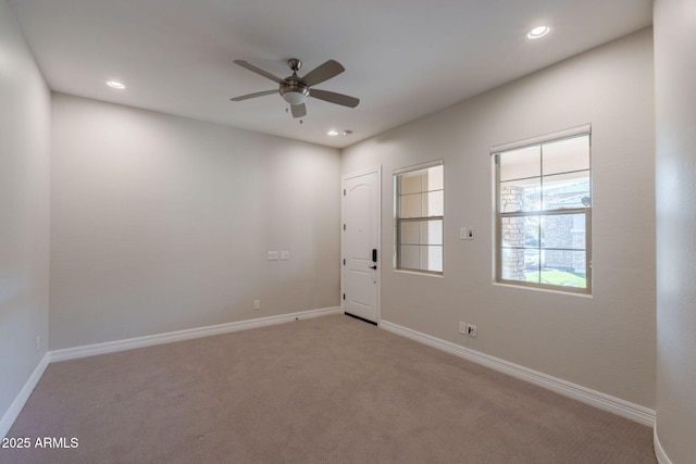 unfurnished room with light carpet and ceiling fan