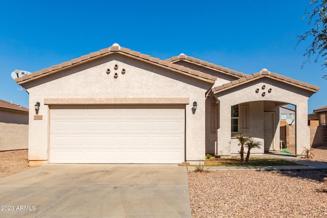 mediterranean / spanish-style home with a garage