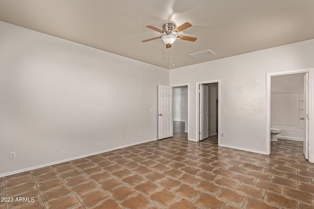 unfurnished bedroom featuring ceiling fan and ensuite bath