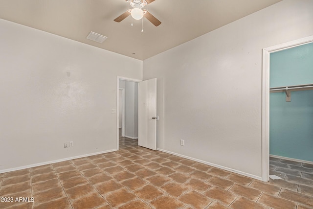 unfurnished bedroom with tile patterned floors, a closet, and ceiling fan