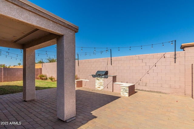 view of patio / terrace featuring an outdoor kitchen and a grill