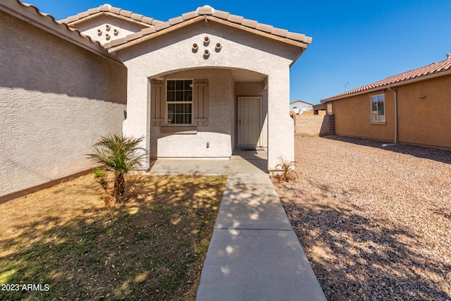 property entrance featuring a patio area