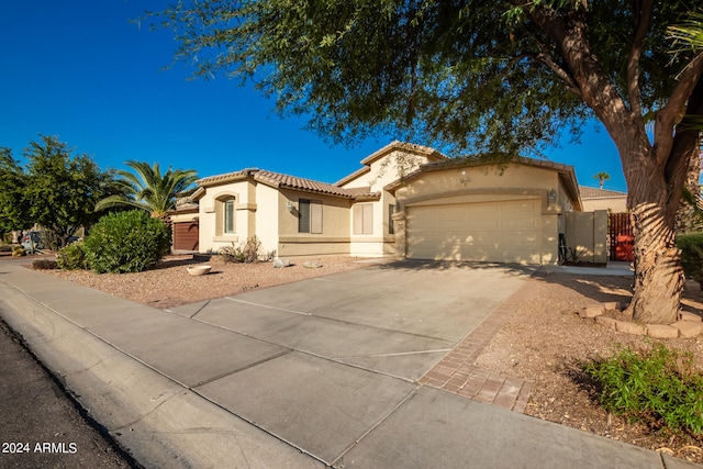 mediterranean / spanish-style home with a garage