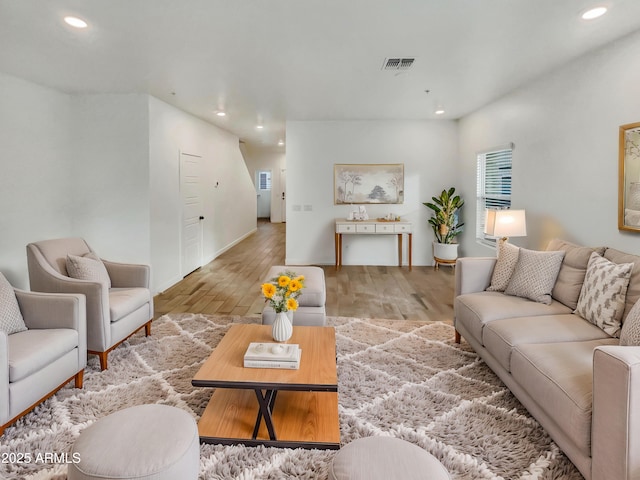 living room featuring visible vents, wood finished floors, and recessed lighting